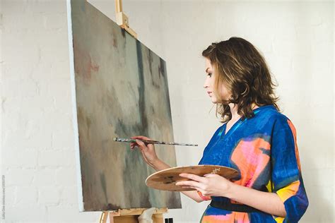 Woman Painting On Canvas In Art Class Del Colaborador De Stocksy