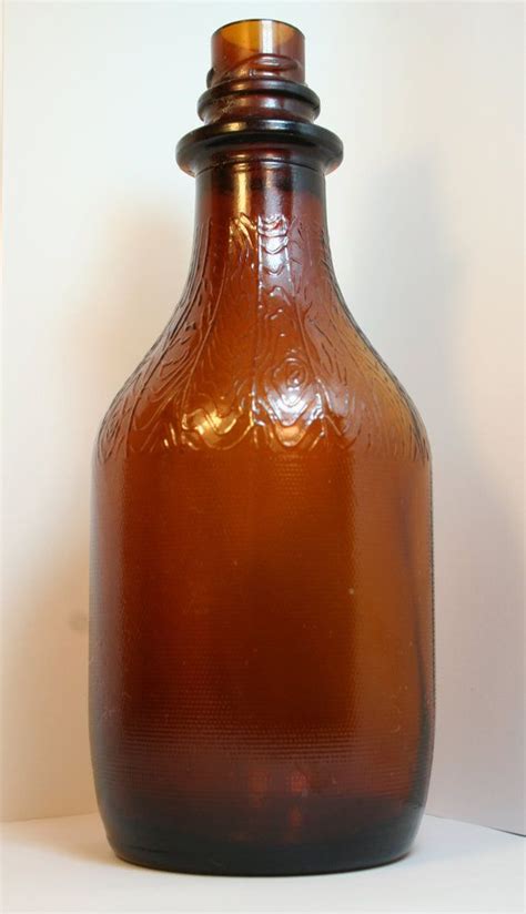 Vintage Brown Glass Bottle With Beautiful Detail Mfd By Nolakitsch Brown Glass Bottles Glass