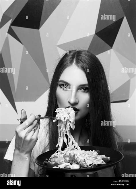 Attractive Woman Eating Seafood Pasta Stock Photo Alamy