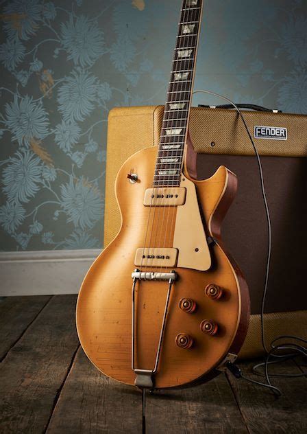 An Electric Guitar Sitting On Top Of A Wooden Floor