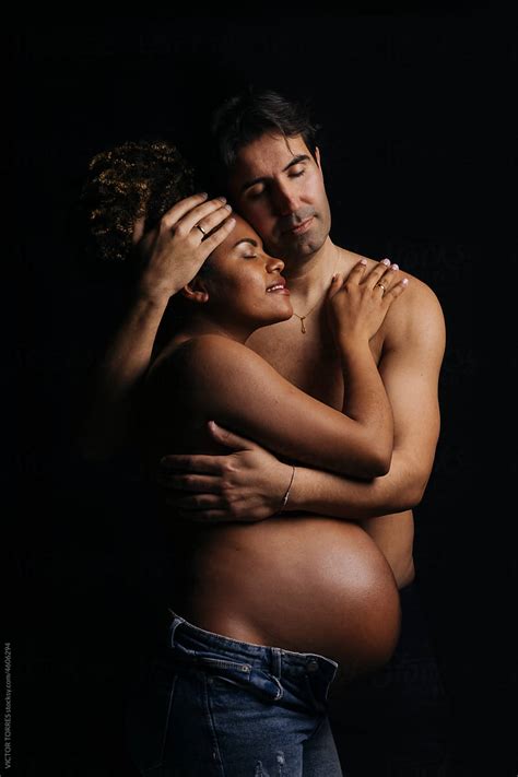 Sensual Naked Pregnant Couple Hugging In Dark Room Del Colaborador De Stocksy Victor Torres