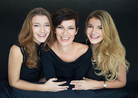 Stunning Mother With Two Teenager Daughters With Long Hair In Studio On