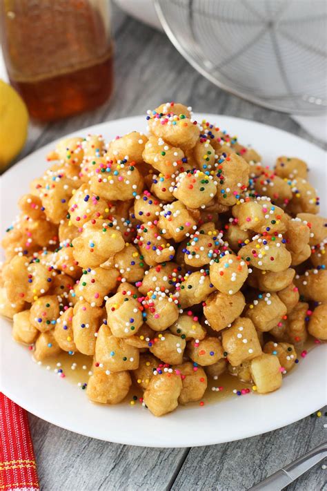 Struffoli are fried dough balls that are covered in honey ...