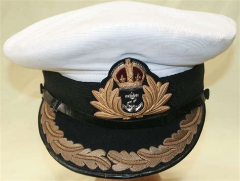 A Pre Wwii Royal Navy Officers Cap Commanders In Helmets And Caps