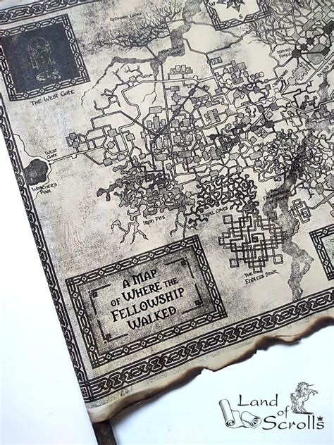 An Old Map Is Laying On Top Of A Piece Of Paper That Says Land Of Scrolls