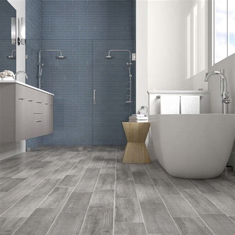 Primary bathroom with a mix of mini tiles and marble tiles walls, along with hardwood flooring. Del Conca Woods Vintage Gray Wood Look Tile - $2.29/ sq ...