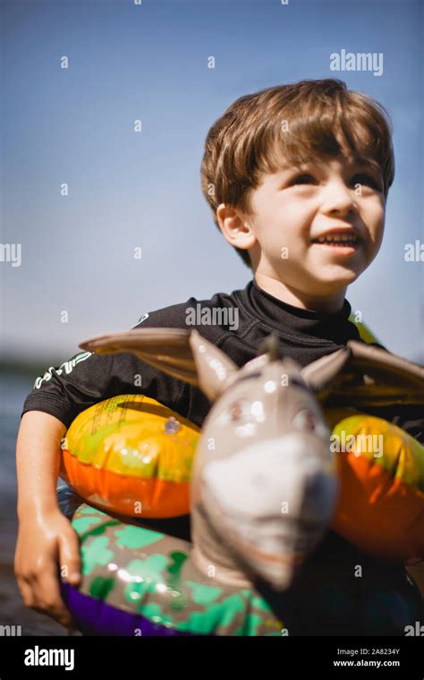 Little Boy Swimming With Floaties Stock Photo Alamy