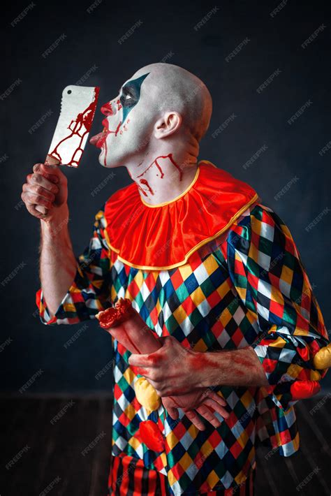Premium Photo Scary Bloody Clown Licks The Knife Blade Man With