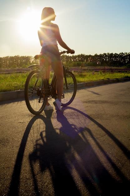 Girl Riding A Bike At Sunset Photo Free Download