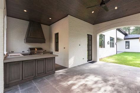 All the homes in your neighborhood are brick. Covered Patio with Walnut Stained Outdoor KItchen Cabinets ...