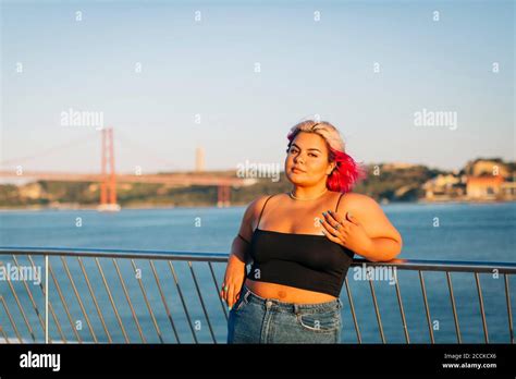 Beautiful Woman Leaning On Railing At The Waterfront Stock Photo Alamy