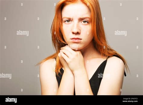 Beautiful Fragile Redheaded Young Woman In The Dark Sad Frightened