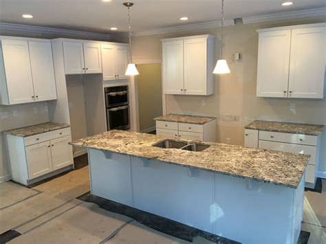 Open concept transitional white kitchen features luxor custom made white shaker cabinets, massive island with comfortable seating, countertops the large granite island creates perfect space for food preparation and seating/eating area. Granite Countertops: Top 25 Best White Granite Colors for ...