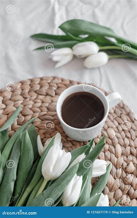 A Bouquet Of White Tulips And A Cup Of Coffee On A Table Stock Image