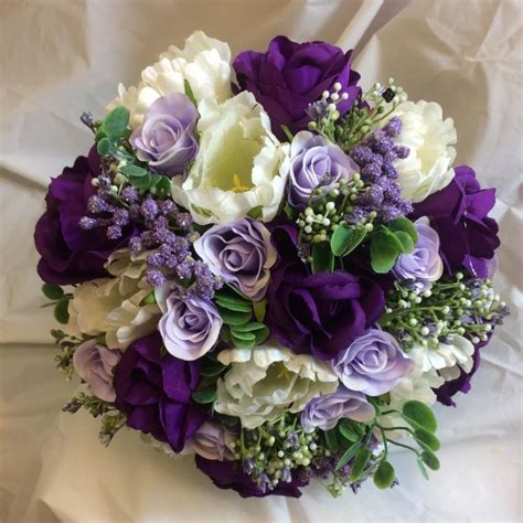 A Bridal Bouquet Of Purple Lilac And Ivory Silk Roses And Tulips