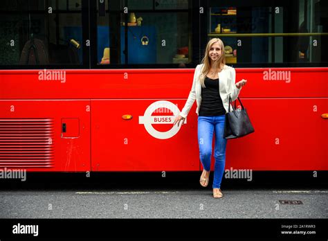 Attractive Young Urban Girl At The Bus Stop To Catch A Red Double Decker Bus In London United