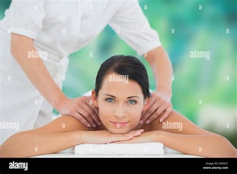 Beautiful Brunette Enjoying A Shoulder Massage Smiling At Camera Stock Photo Alamy
