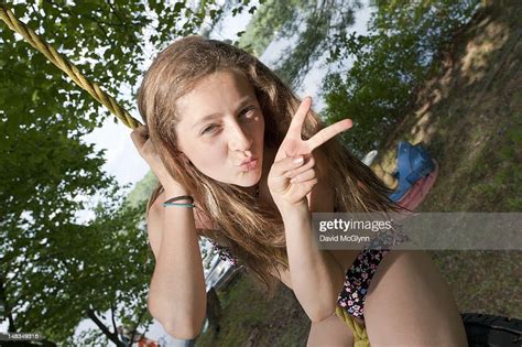 Girl On A Rope Swing Flashing A Peace Sign Photo Getty Images