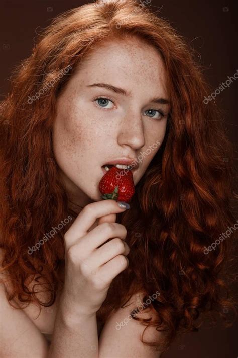 Redhead Woman Eating Strawberry Stock Photo VadimVasenin