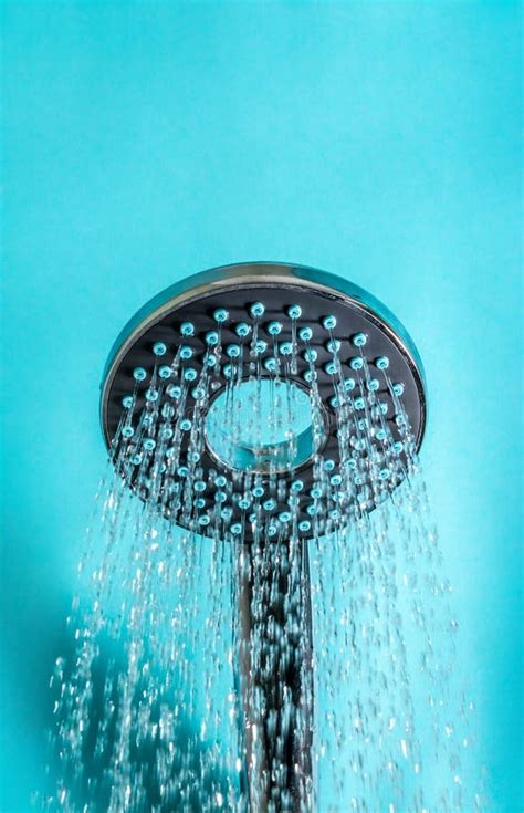 Modern Hot Shower With Stream Of Water Close Up On A Blue Stock Image