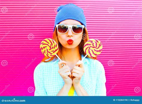 Sweet Woman Holds Two A Lollipops Is Having Fun On Colorful Pink Stock Photo Image Of Glasses