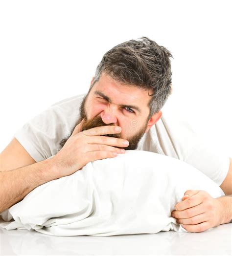 Man With Sleepy Yawning Face Stretching While Lay In Bed Stock Image