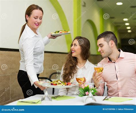 Waitress Serving Food To Visitors Stock Photo Image 62100986