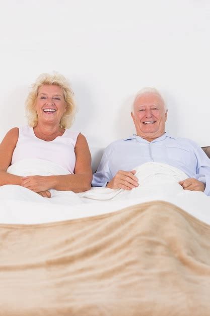 Premium Photo Aged Couple Lying On The Bed