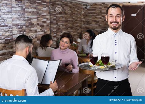 Waiter Welcoming Guests In Restaurant Stock Image Image Of Enjoyment