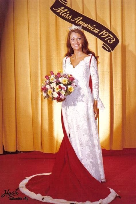A Woman In A White And Red Wedding Gown Holding A Bouquet Of Flowers