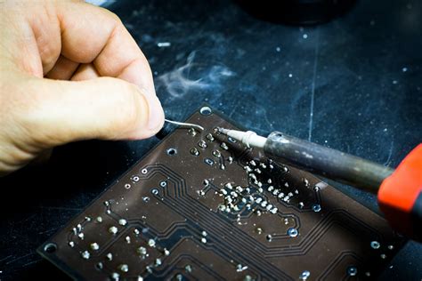 Person Soldering Chip · Free Stock Photo