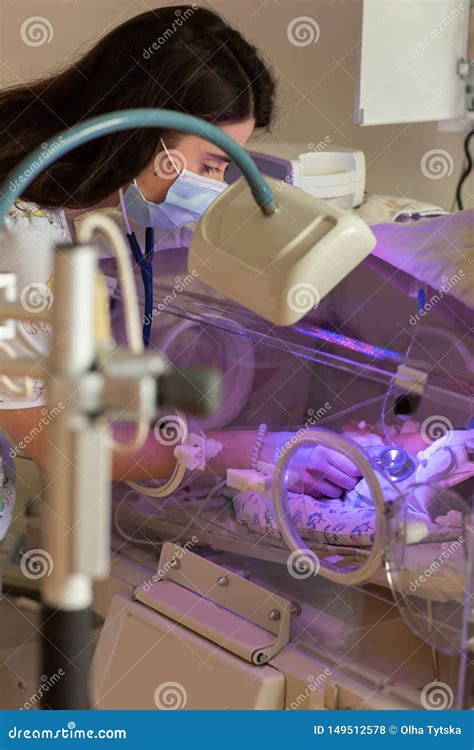 Female Doctor Examining Newborn Baby In Incubator Stock Photo Image