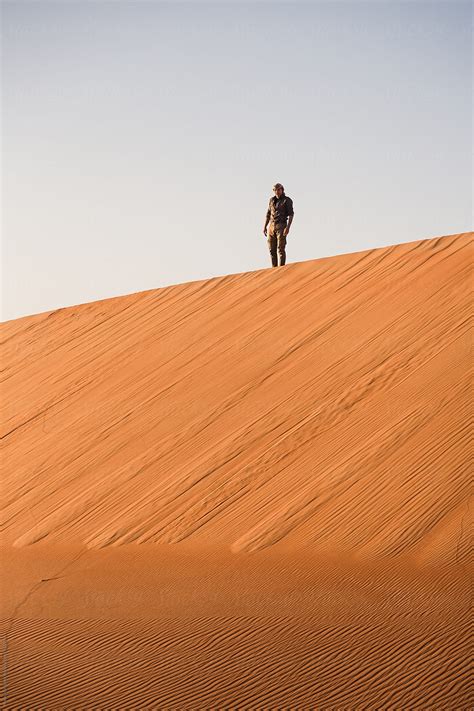 Man Alone On A Dune In A Desert By Stocksy Contributor Mauro