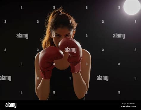 Woman Wearing Boxing Gloves Ready To Throw A Punch Stock Photo Alamy