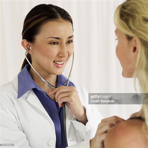Closeup Of A Female Doctor Examining A Patient With A Stethoscope High
