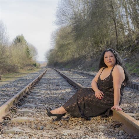 Woman Sitting On The Train Tracks Looking At You Stock Image Image Of