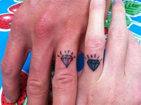 Two People With Matching Tattoos On Their Fingers One Has A Diamond And The Other Has A Heart