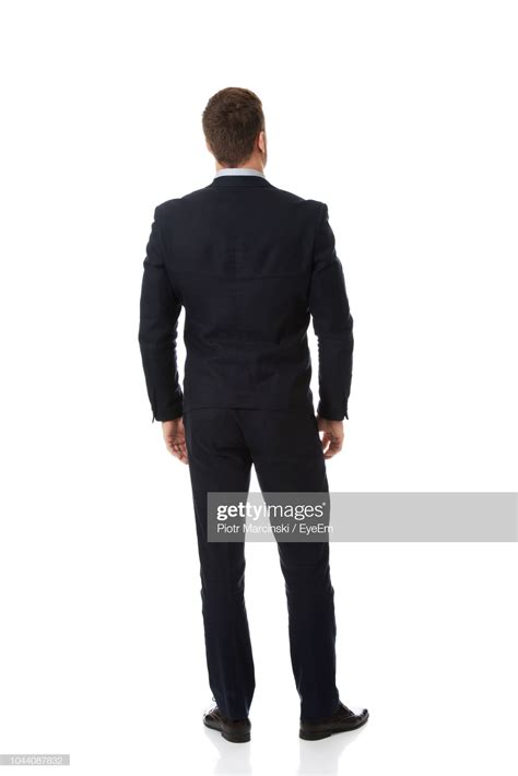 Stock Photo Rear View Of Businessman Standing Against White