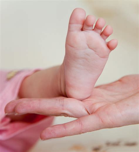 Babys Feet On Persons Hand · Free Stock Photo