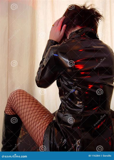 Woman In Black Pvc Coat And Red Fishnet Stockings Stock Photo Image