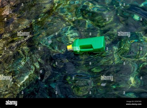 From Above Plastic Bottle Floating In Water Polluting Environment Stock