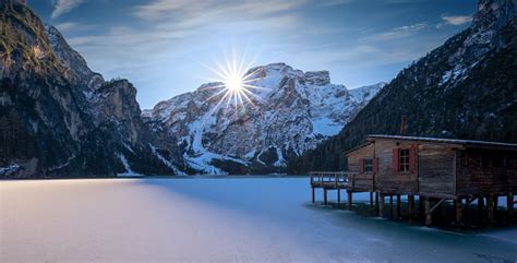 Beautiful Frozen Alpine Lake With A Wooden Hut Lago Di Braies In Winter