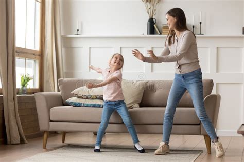 Happy Young Mother Dancing With Little Daughter At Home Stock Image