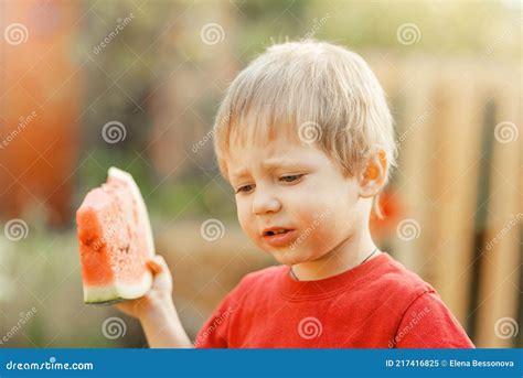 Funny Kid Eating Watermelon Outdoors In Summer Park Stock Image