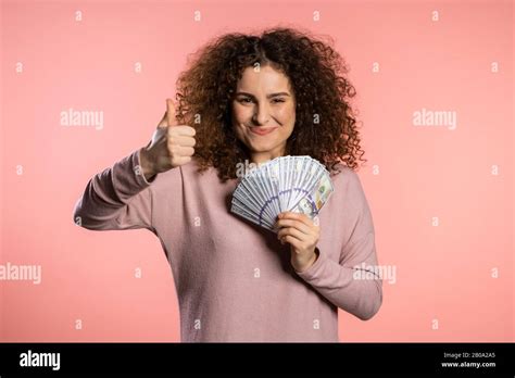 Happy Excited Girl In Pink Sweater Showing Money Us Currency