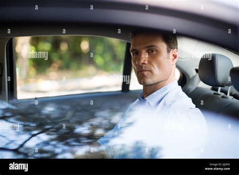 Portrait Of Confident Man Sitting On Car Back Seat Stock Photo Alamy