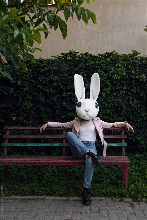 Woman In Rabbit Mask Sitting On Bench Del Colaborador De Stocksy Danil Nevsky Stocksy