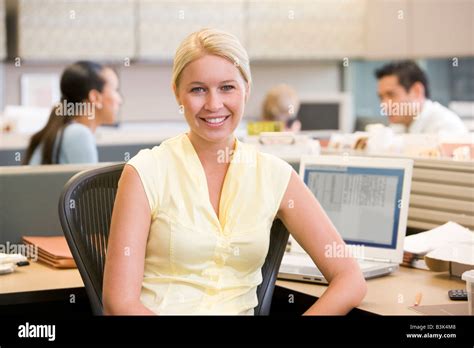 Businesswoman In Cubicle Smiling Stock Photo Alamy