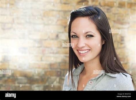 Portrait Of Young Woman In Front Of Wall Stock Photo Alamy