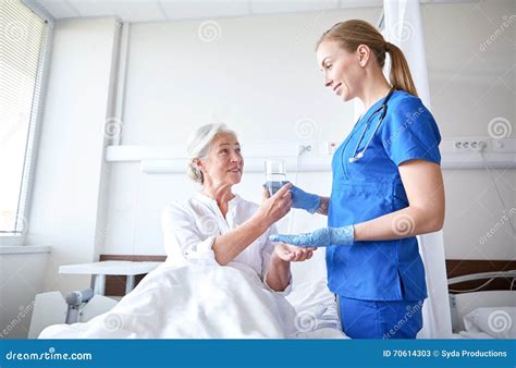 Nurse Giving Medicine To Senior Woman At Hospital Stock Image Image